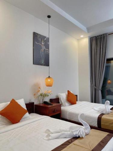a hotel room with two beds and a window at Meatophum Samnang in Battambang