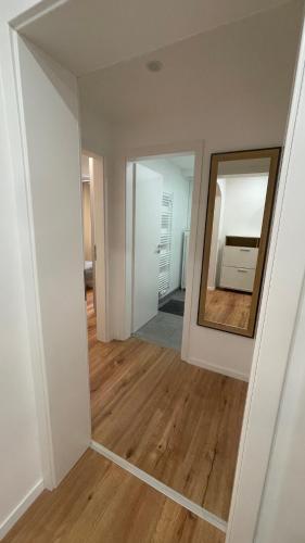 an empty room with a mirror and a wooden floor at Ferienwohnung Bayer in Gründau