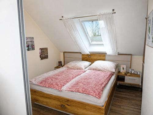 a bedroom with a large bed with a window at Carmen u. Rudolf Lutz in Norddeich