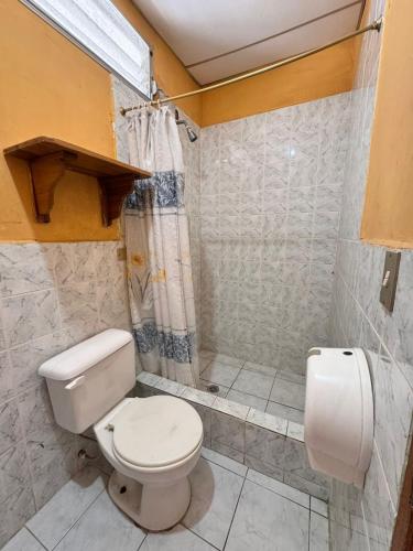 a bathroom with a toilet and a shower at Hotel Barbasquillo in Manta