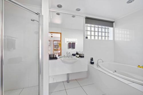 a white bathroom with a tub and a sink at Comfort Inn Lady Augusta in Swan Hill