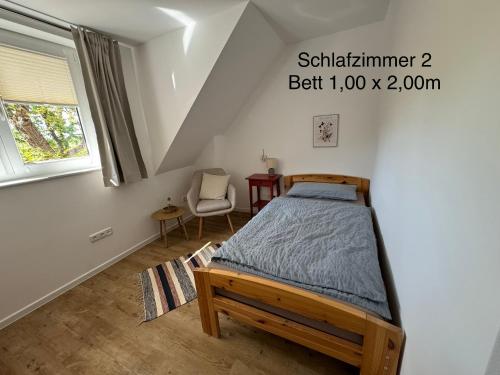 a bedroom with a bed and a chair at Brokeloh - Hier bin ich zuhause ! in Landesbergen