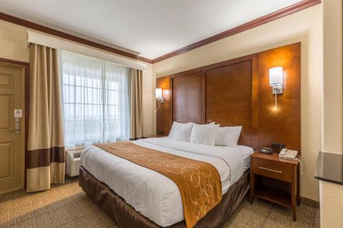 a hotel room with a large bed and a television at Comfort Suites Galveston Cruise Port Area - Beachside in Galveston