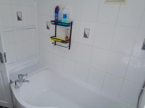 a bathroom with a white tub and a sink at mapa in Birmingham