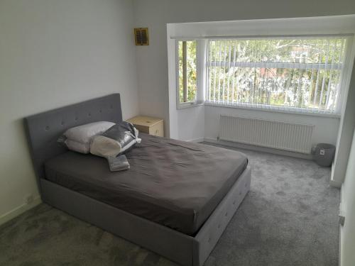 a bed in a bedroom with a large window at mapa in Birmingham