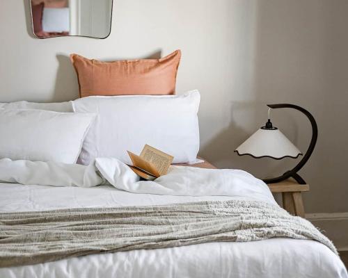 a bedroom with a bed with a book on it at Little Elizabeth in West Hobart