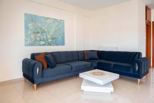 a blue couch sitting in a living room at 3 Bedroom Apartment, Easy Parking in Alexandroupoli