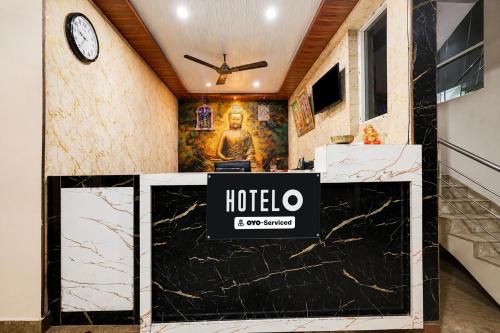 a hotel lobby with a reception desk and a clock at Hotel O Visakhapatnam Railway Junction Formerly Kesava Residency in Visakhapatnam