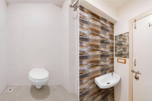 a bathroom with a toilet and a sink at Hotel O Sabarmati Ashram Ahmedabad Formerly Red Apple in Ahmedabad