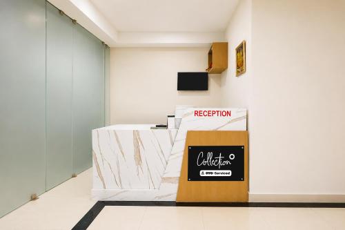 a reception desk in a room with a sign on the wall at Collection O Rajgir Railway Station Formerly Hotel Swastik in Ekangar Sarai