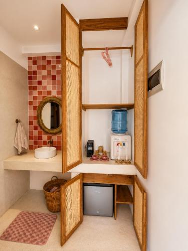 a bathroom with a mirror and a sink at Navi - Boutique Hotel - Adults Only in Ahangama