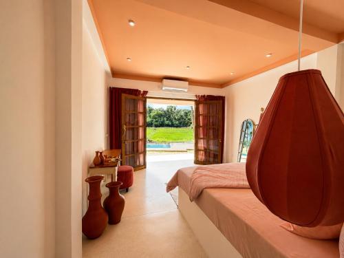 a bedroom with a bed with a large wooden headboard at Navi - Boutique Hotel - Adults Only in Ahangama