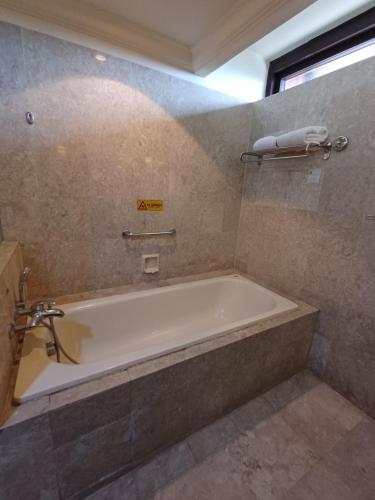 a bathroom with a bath tub in a room at Home Time Square Residence in Kuala Lumpur