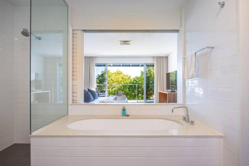 a bathroom with a large sink and a mirror at 3BR Golfside Villa | Pools, Tennis & Relaxation in Magenta