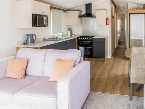 a living room with a couch and a kitchen at Luna - Ukc9719 in Aston