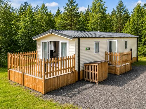 a tiny house with a wooden fence and trees at Luna - Ukc9719 in Aston