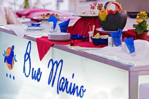 a table with plates of food on top of a table at BUE MARINO Hotel & Roof Lounge in Cala Gonone