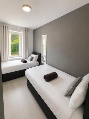 a bedroom with two beds and a window at SeaView Apartment Suite in Cobh