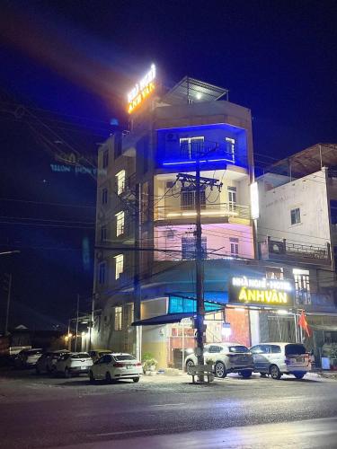 a building with cars parked in front of it at night at ANH VAN Motel in Chau Doc