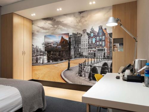 a bedroom with a wall mural of a city at Mercure Hotel Schiphol Terminal in Schiphol