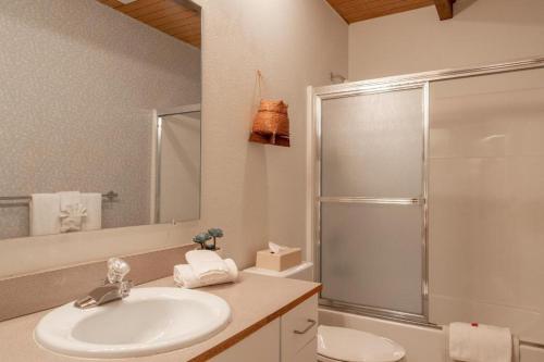 a white bathroom with a sink and a shower at Wapato Point Resort in Manson