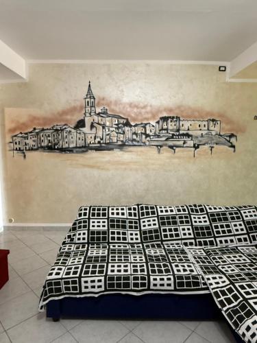 a bedroom with a bed with a drawing on the wall at Il mondo di Leo in Tocco da Casauria