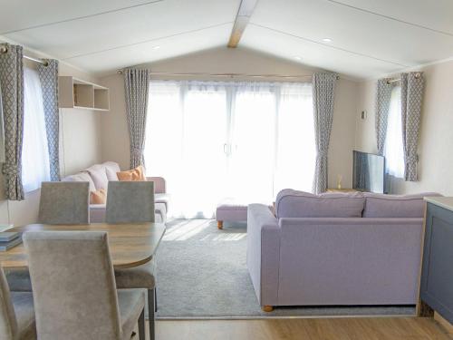 a living room with a couch and a table at Nova - Ukc9932 in Aston
