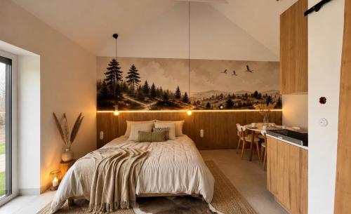 a bedroom with a bed and a kitchen with a table at Zakopiański klimat w sercu Lubelszczyzny, klimatyzowane in Okszów