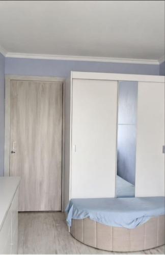 a bedroom with a bed and a window at Kвартира -студия in Daugavpils