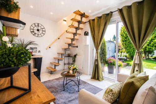 a living room with a spiral staircase in a house at Magic Disney 5mn Peaceful Home Garden Parking in Chessy