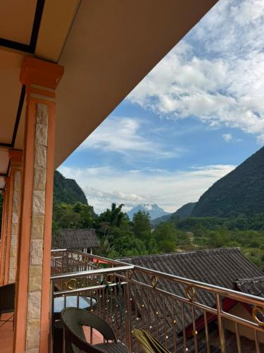 a balcony with chairs and a view of mountains at Nam Ou Breeze in Ban Ngoy-Nua