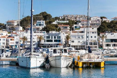 a group of boats docked in a harbor with buildings at Emporda Llanca Guesthouse in Llança