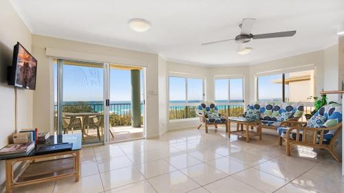 a living room with a view of the ocean at Pacific Waves Apartments in Noosa Heads