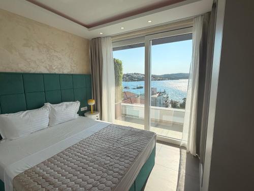 a bedroom with a bed and a large window at Apartments Soho in Trogir