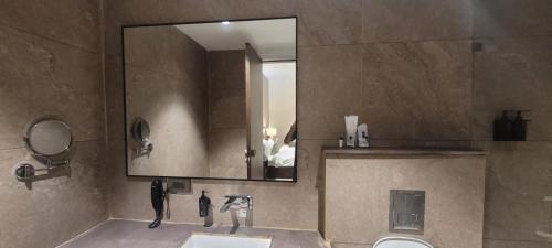 a bathroom with a sink and a mirror at Kiwa Banquet & Hotel in Koba