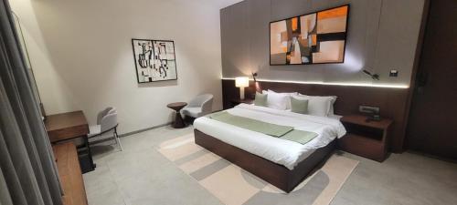 a hotel room with a bed and a table and a desk at Kiwa Banquet & Hotel in Koba