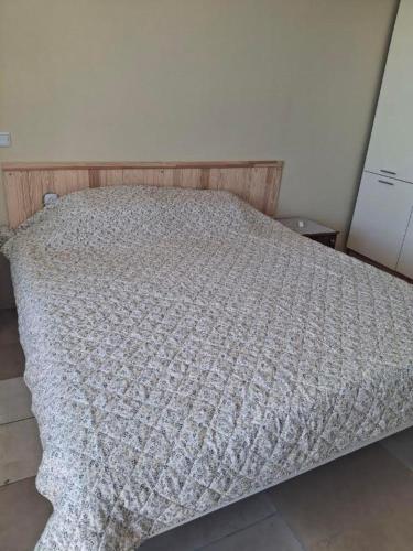 a bed with a blanket on it in a bedroom at Закоханий у море in Odesa