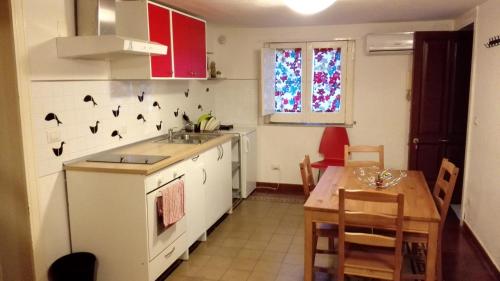 a kitchen with a sink and a table in it at Le Coccole in Catania