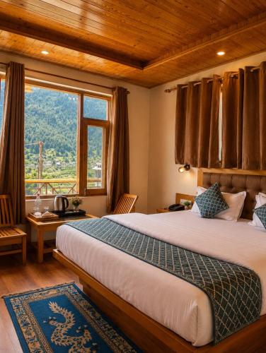 a bedroom with a large bed and a large window at Lime Tree Haven in Kulu
