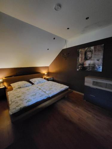 a bedroom with a bed and a tv on the wall at Hani's Partyhaus in Verl