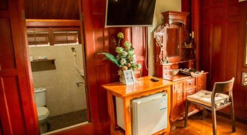 a bathroom with a sink and a toilet and a counter at Doembang Villa in Ban Tha Pong