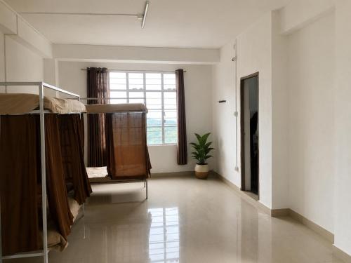 a room with two bunk beds and a window at Naga Hills Backpacker Hostel in Kohīma