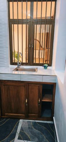 a kitchen with a sink and a window at chama haven apartments in Nkoanrua