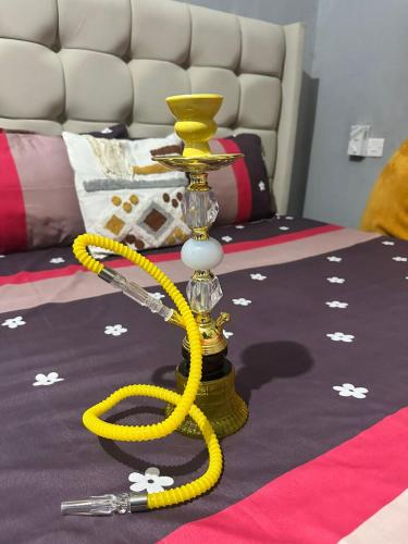 a yellow hoola hoop with a yellow rope on a bed at The Mason Hideout in Watamu