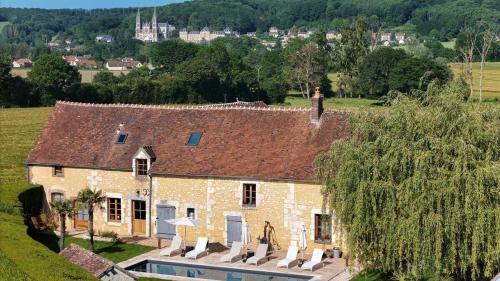 a house with a swimming pool in front of it at RELAI VALDIEU in Courgeon
