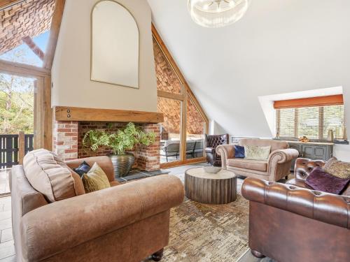 a living room with leather furniture and a fireplace at The Penthouse - Uk52276 in Beccles