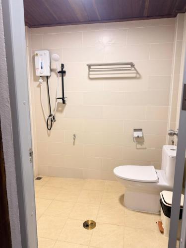 a bathroom with a toilet and a phone on the wall at TakFha Café & Resort in Ban Tha Ngam (1)