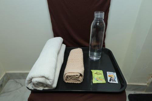 a tray with two towels and a bottle of water at Hotel SR Imperial in Kolkata