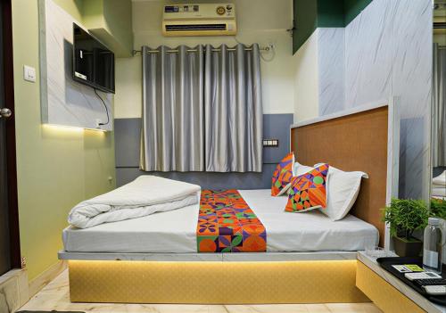a small bedroom with a bed with at Hotel SR Imperial in Kolkata
