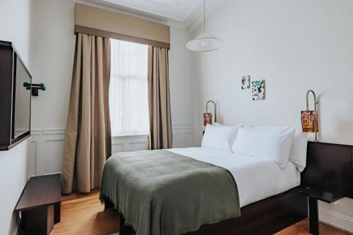 a hotel room with a bed and a window at Arthouse Glasgow - Newly Refurbished in Glasgow